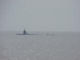 USS Hartford with people standing by on the deck as the lifeboat approaches